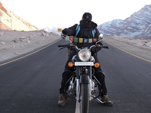 This Man is taking the challenge of riding a 110 cc motorbike from Bangalore to Bangkok