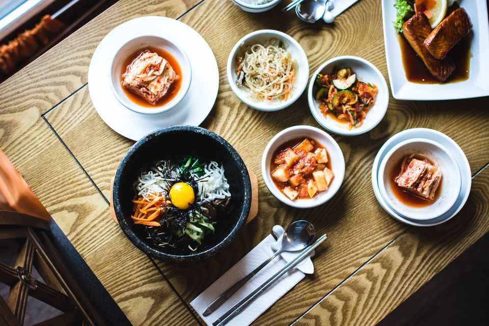 7 Delightful Korean Restaurants In Delhi For A Culinary Adventure The steamed rice cakes are stirred up.